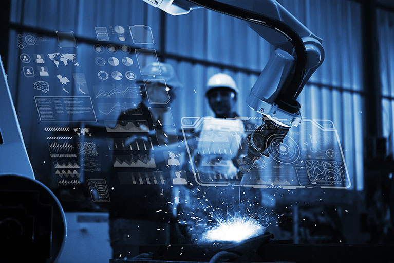 An engineer working with automation robot arms machine on real time monitoring system software