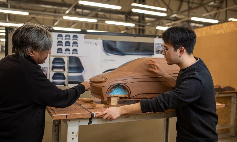 Students working on model of a automotive vehicle 