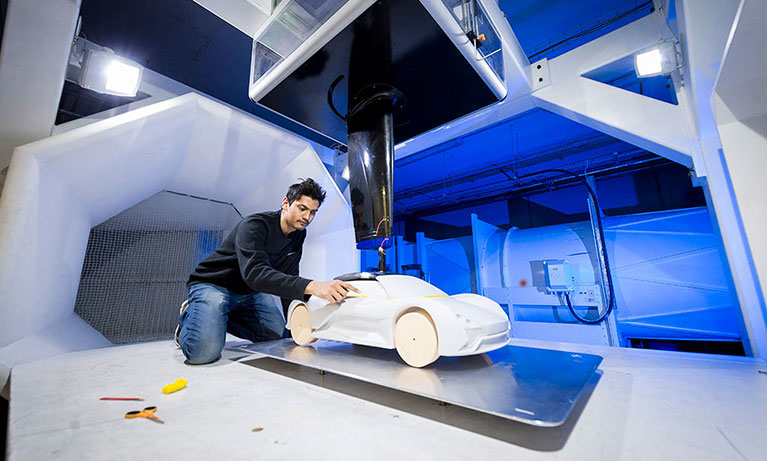 Student working on a clay model car