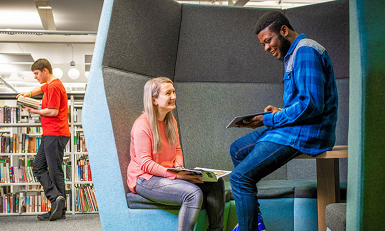 Student sitting in a library space