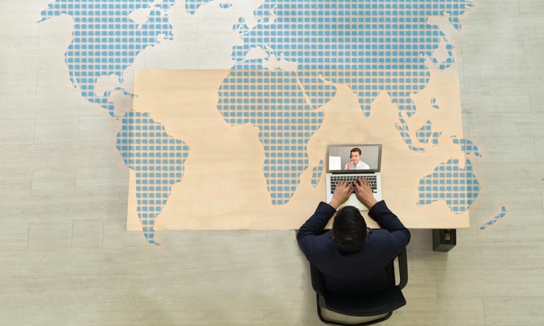 Top down view of man working at desk on laptop