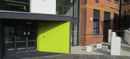 the front of the Elm Bank building, featuring a bright green wall