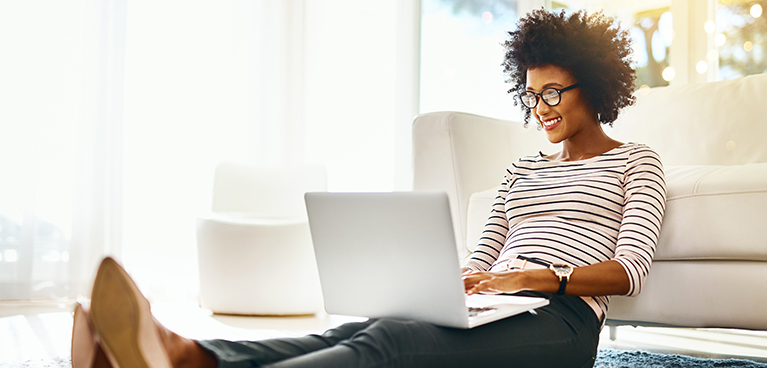 Woman sat on her laptop