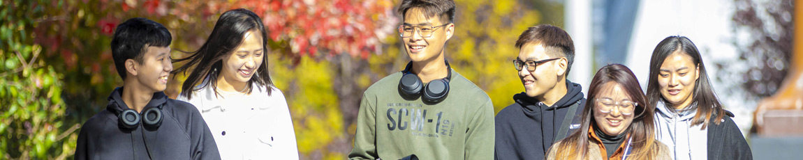 A group of international students walking outside on campus