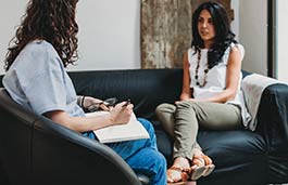 two people sitting on a couch