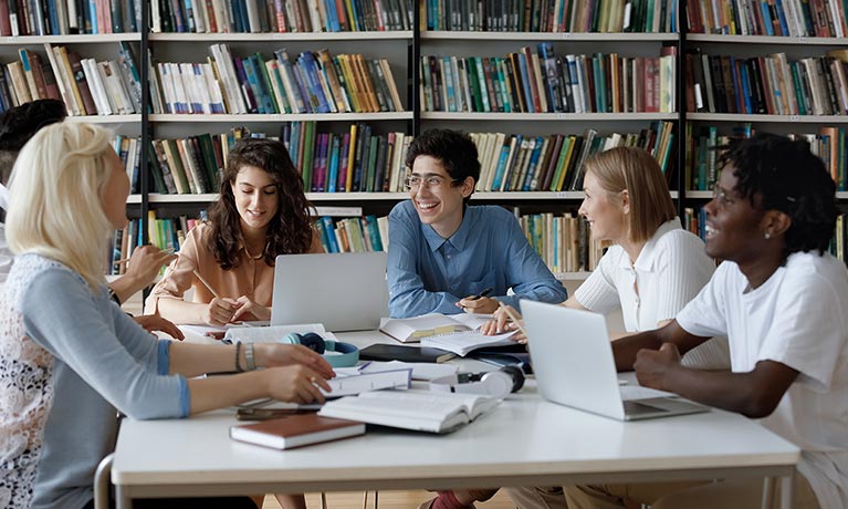 Students around a table doing work