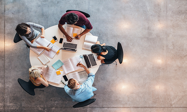 Students working around a circular table, seen from above